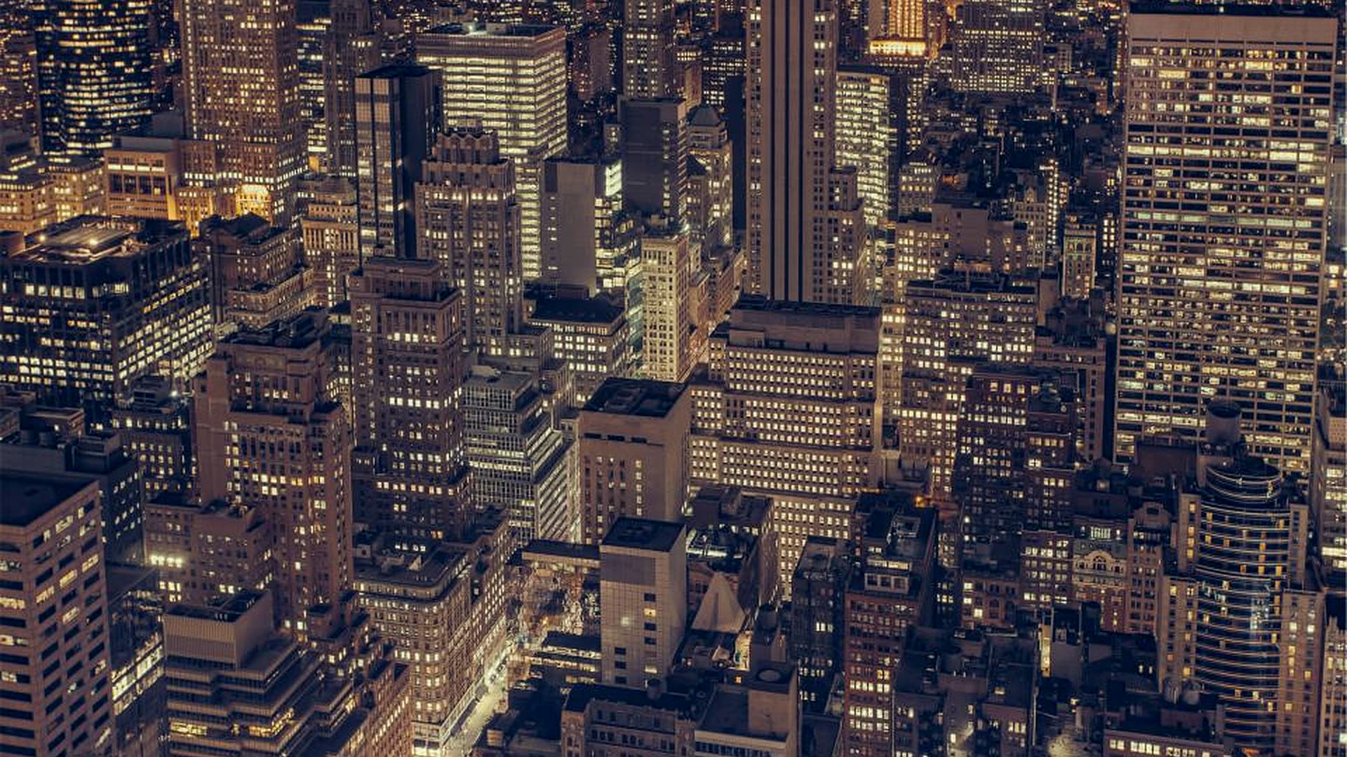 A dense city skyline seen from above at dusk
